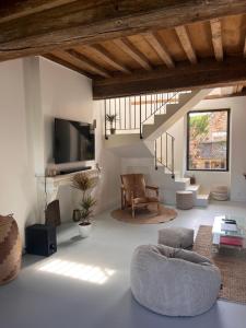 a living room with a couch and a tv at Le Meix Saint Vital in Barizey