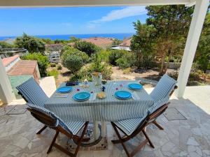 a table with blue plates on it on a patio at Casa Vacanze Miranda in Torre Dei Corsari