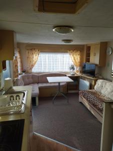 a living room with a couch and a table at Lucy in Władysławowo