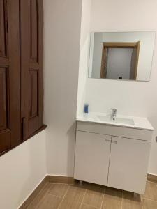 a bathroom with a white sink and a mirror at Casa de Pedra in Pedrógão Grande