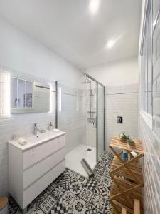 a white bathroom with a sink and a shower at Chambres d'hôtes Les Carmélites in Guingamp +45 photos