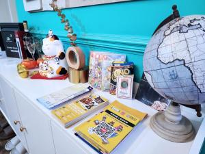 a desk with books and a globe on it at Pillows CoLiving in Hong Kong