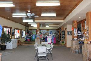 a room with a table and chairs in a store at Whitney Portal Hotel And Hostel in Lone Pine