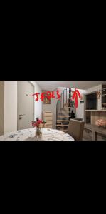 a kitchen with a table with a vase of flowers on it at L'Escale chambres priv&eacute;es chez l'habitant JFDL in Bonifacio