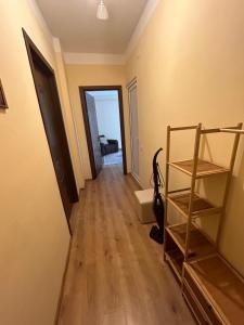 a hallway of a house with a wooden floor at Family Trip in Kutaisi