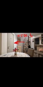 a kitchen with a table and a staircase in a room at L'Escale chambres priv&eacute;es chez l'habitant JFDL in Bonifacio