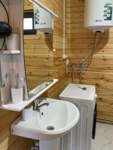 a bathroom with a sink and a mirror at Beach HOUSE in Cholpon-Ata +10 photos