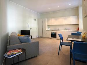 a living room with a couch and a table and a kitchen at Appartamento Carnival 9 in Muralto
