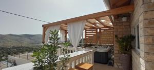 a balcony with a tub and a sink at Holiday Home Peran in Grebaštica