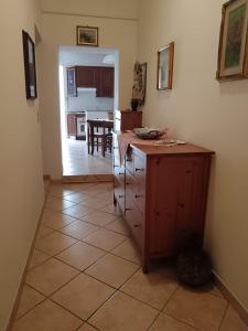 a kitchen with a counter and a dining room at Piccione Marittimo Appartamento Vicinanze Mare in Livorno +5 photos