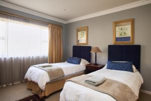 a hotel room with two beds and a window at Villa Mohau 178 in Clarens