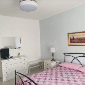 a bedroom with a pink bed and a dresser at Casa Josè in Marta