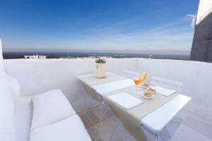 a white table and chairs on a balcony with a view at Casa Zio Piero in Ostuni