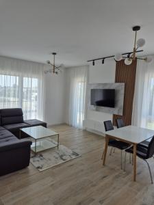 a living room with a couch and a table at Frekuenca Apartments in Ulcinj