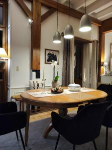 a dining room with a wooden table and chairs at Chambres d'hôtes Les Carmélites in Guingamp