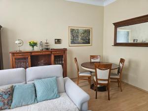 a living room with a couch and a table at Apartament u Teresy in Olsztyn +14 photos
