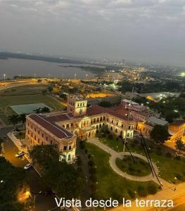 an overhead view of a large building in a city at Vista al Río Paraguay, Costanera Asu in Asuncion