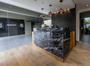 a lobby with a counter with black granite at Vista al Río Paraguay, Costanera Asu in Asuncion +50 photos