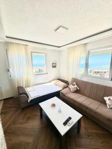 a living room with a couch and a table at Montenegrina Apartment in Budva