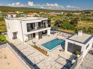 an aerial view of a house with a swimming pool at Modern 4BR Private Villa - Pool, Jacuzzi, Gaming Room in Bibinje