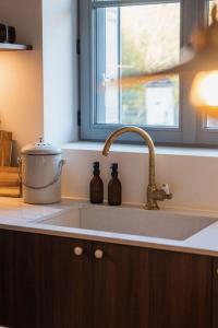 a kitchen sink with two bottles in a window at Les Biches, Maison Familiale jusqu'à 10 personnes in Noyers-sur-Cher +39 photos
