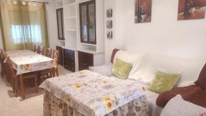 a living room with a couch and a table at Unifamiliar Las Torres in Sanlúcar de Barrameda