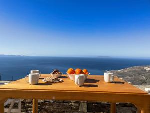 a wooden table with a bowl of fruit on it at Casa Ostria in Istérnia