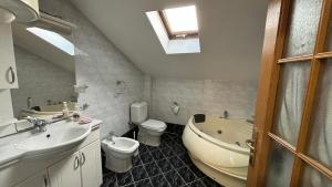 a bathroom with a sink and a toilet and a tub at D&S Apartment Ohrid in Ohrid +4 photos