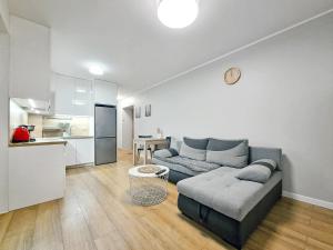 a living room with a couch and a kitchen at CLASSY APARTMENTS - AQUAPARK Reda III in Rumia