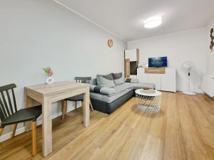 a living room with a couch and a table at CLASSY APARTMENTS - AQUAPARK Reda III in Rumia
