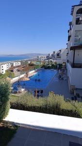 a swimming pool in a resort with people in it at Appartement bella vista in Cabo Negro