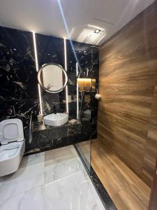 a bathroom with a toilet and a sink and a mirror at Appartement bella vista in Cabo Negro