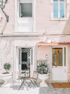 a couple of chairs sitting outside of a building at CerezinoFlats- Blue Bay Studio in Seixal