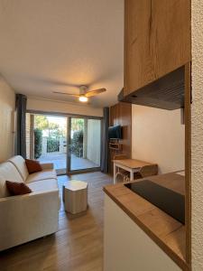 a living room with a couch and a table at Studio avec jardin front de mer in Argelès-sur-Mer