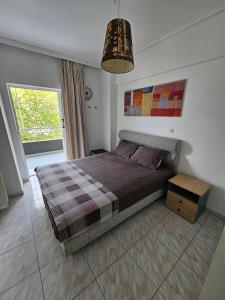 a bedroom with a bed and a pendant light at Seaside Apartment - Charlie's House in Chalkida