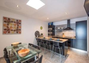 a kitchen with a glass table and a counter at Villa Maiteren Etxea- 4 Beds property with private pool in Playa Blanca