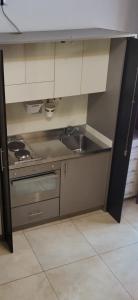 a kitchen with a sink and a stove at Residence Hotel Le Viole in Rimini +70 photos