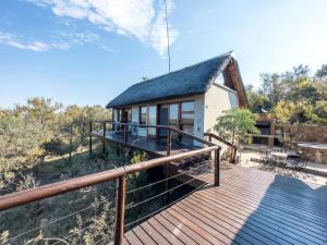 a house on a wooden deck with a roof at Des'lgodini Lodge - PRM078 in Bela-Bela