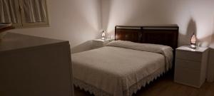a bedroom with a bed and two night stands at Casa Giulia in Castelbuono
