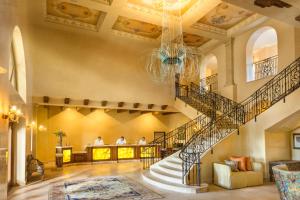a lobby with a spiral staircase with people in the background at Allegretto Vineyard Resort Paso Robles in Paso Robles