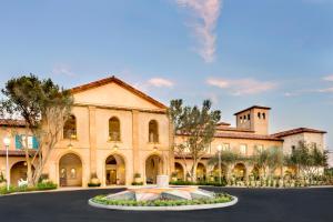 a large building with a large clock on the front of it at Allegretto Vineyard Resort Paso Robles in Paso Robles
