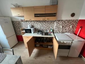 a small kitchen with a sink and a microwave at -Self-Check- downtown Apartment in city center in Nitra