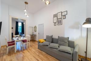 a living room with a couch and a table at Historic 5 star apartment in the main plaza in Cluj-Napoca