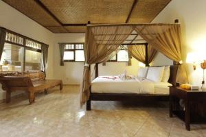 Llit o llits en una habitació de Pekak Mangku Guest House