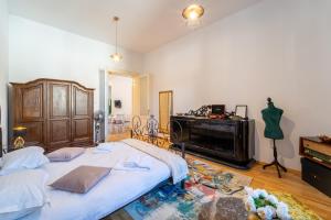 a bedroom with two beds and a piano at Historic 5 star apartment in the main plaza in Cluj-Napoca