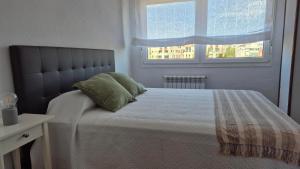 a bedroom with a large bed with a window at El Espolón de Valdenoja in Santander +11 photos