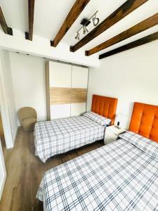 a room with two beds in a room at Apto-1 Pedreña Golf y Surf in Pedreña