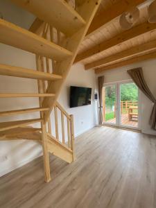 a large room with wooden stairs in a house at Zakątek Pierszczewo Kaszuby in Pierszczewko