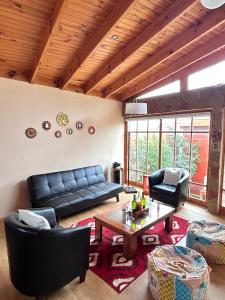 a living room with a couch and a table at alojamiento Lof tüng in Los Vilos