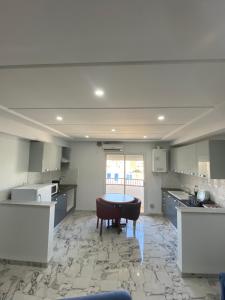 a large kitchen with a table in the middle at Residence ElFaracha in Sousse